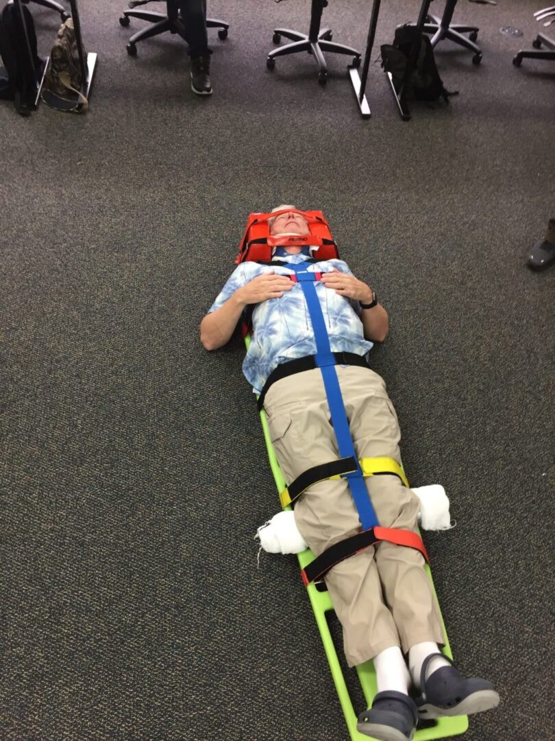 a man on a spinal board stretcher